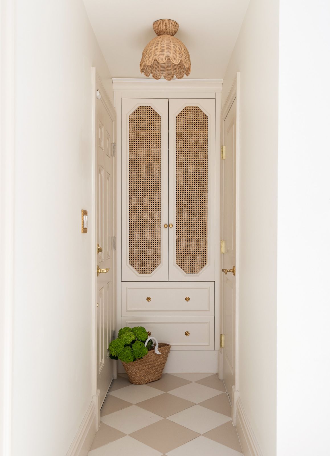 Hallway cabinet with cane doors and scalloped rattan light