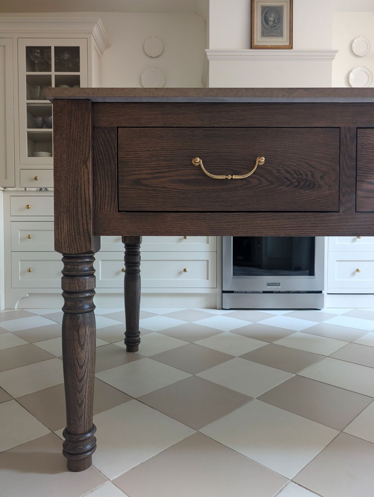 Turned oak island leg with brass pull