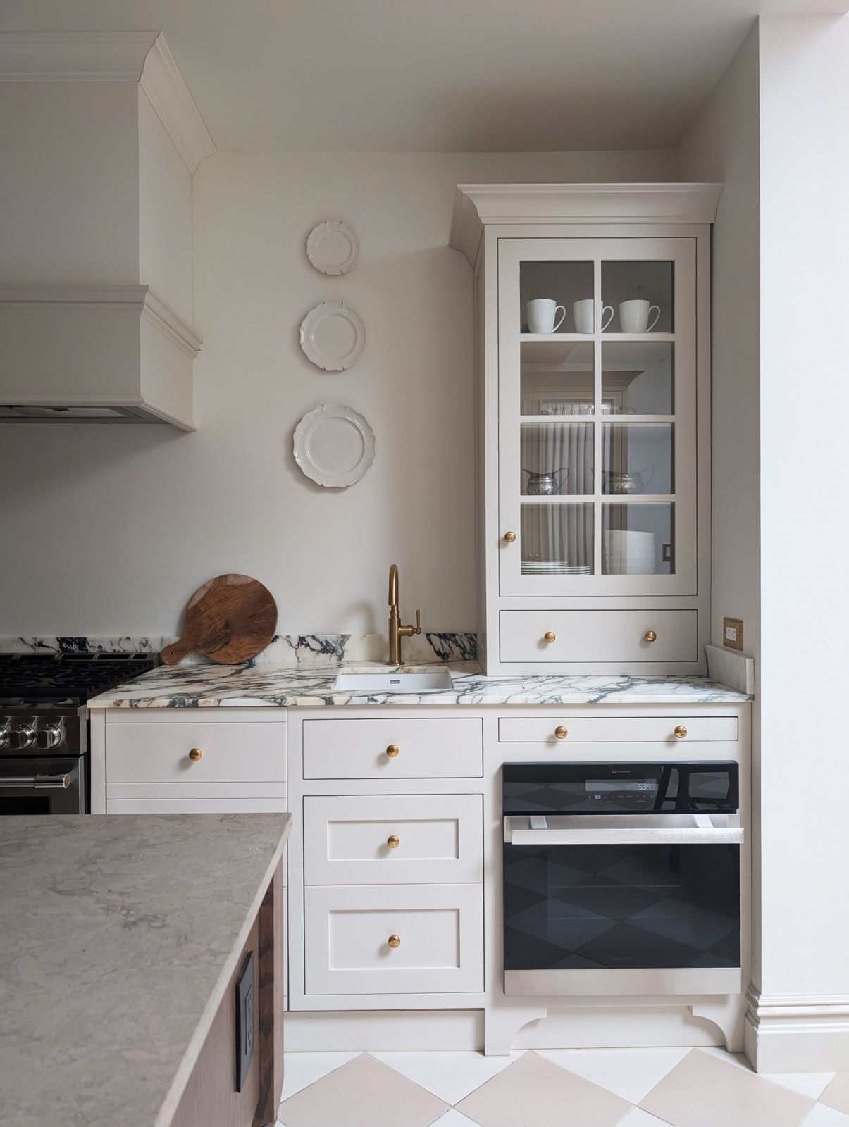 Glazed cabinet, calacatta viola marble and brass tap
