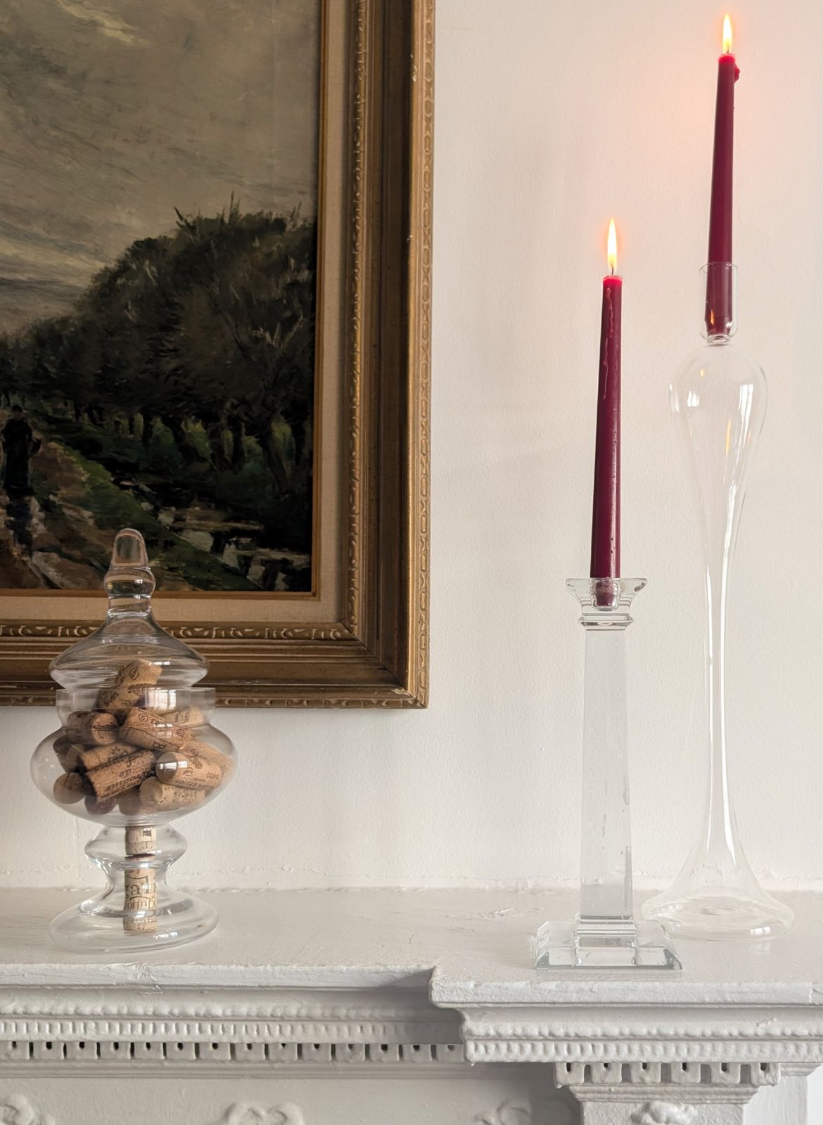Mantel with glass candlesticks and gilt-framed landscape