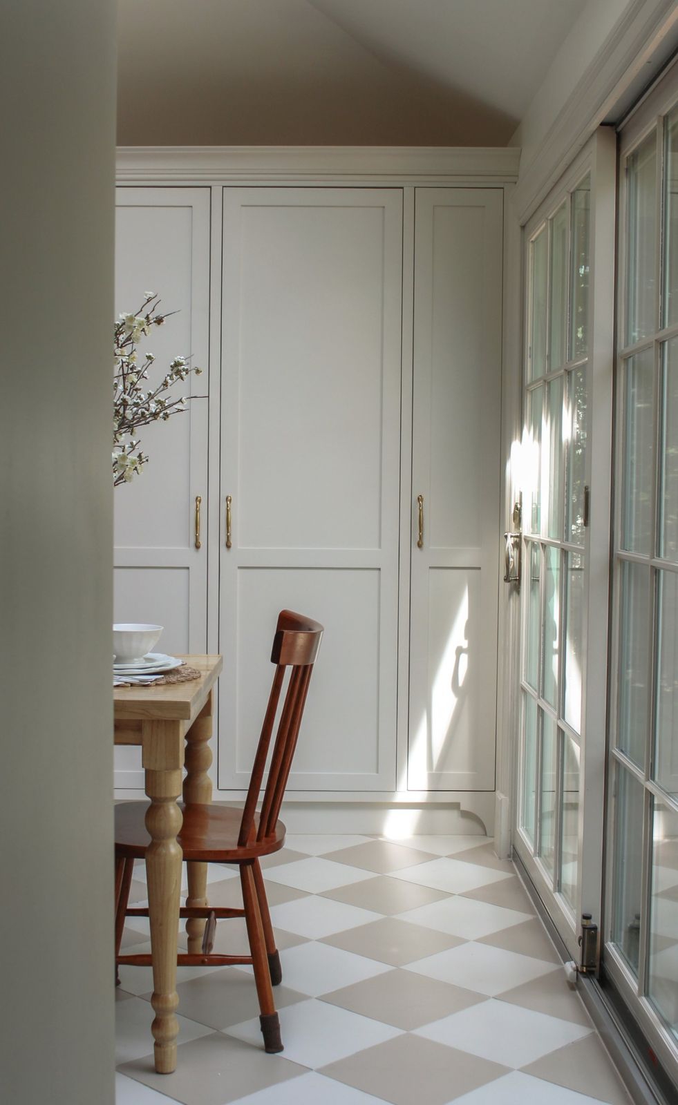 Built-in pantry cabinetry beside French doors