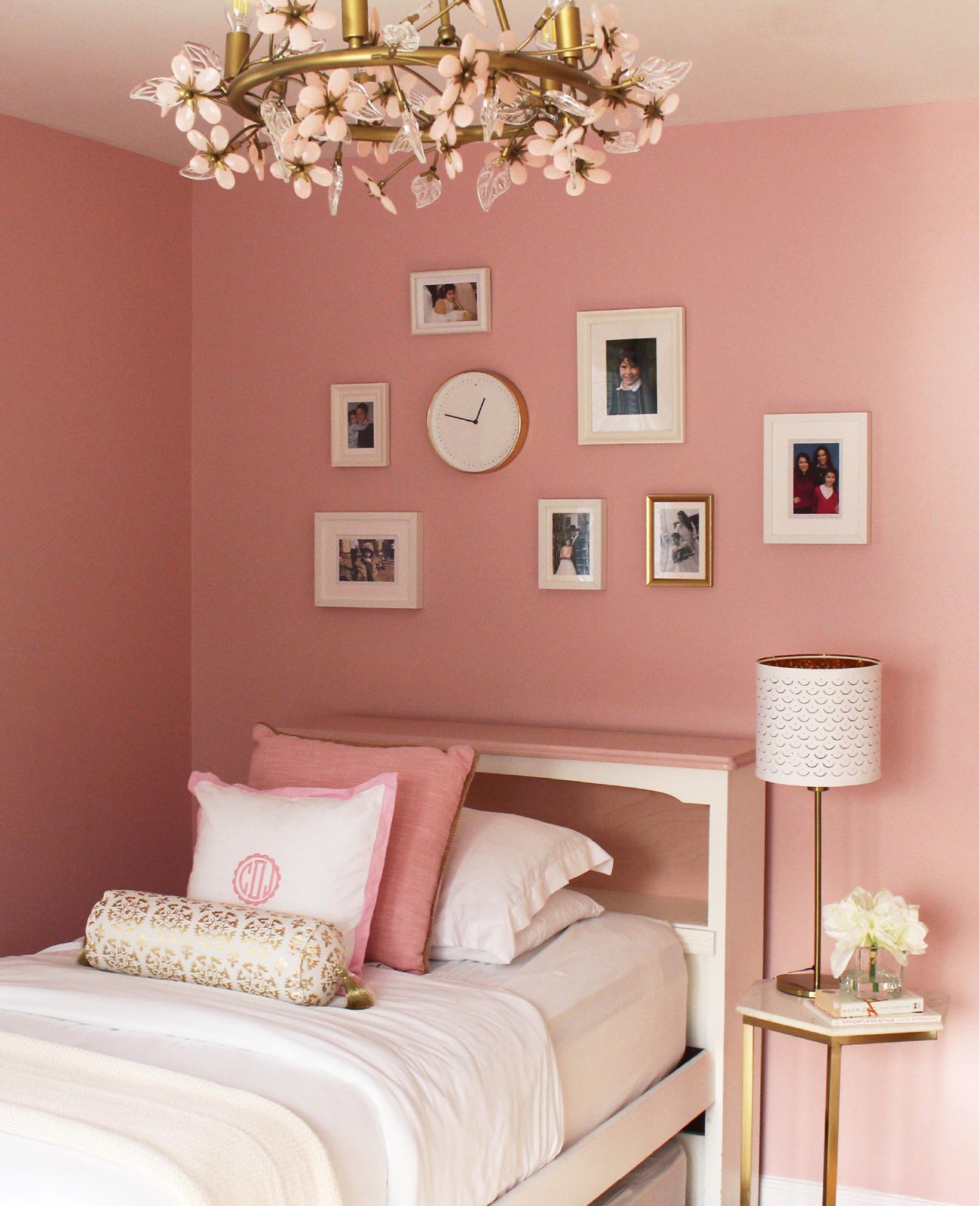 Rose-pink bedroom with floral chandelier and gallery wall