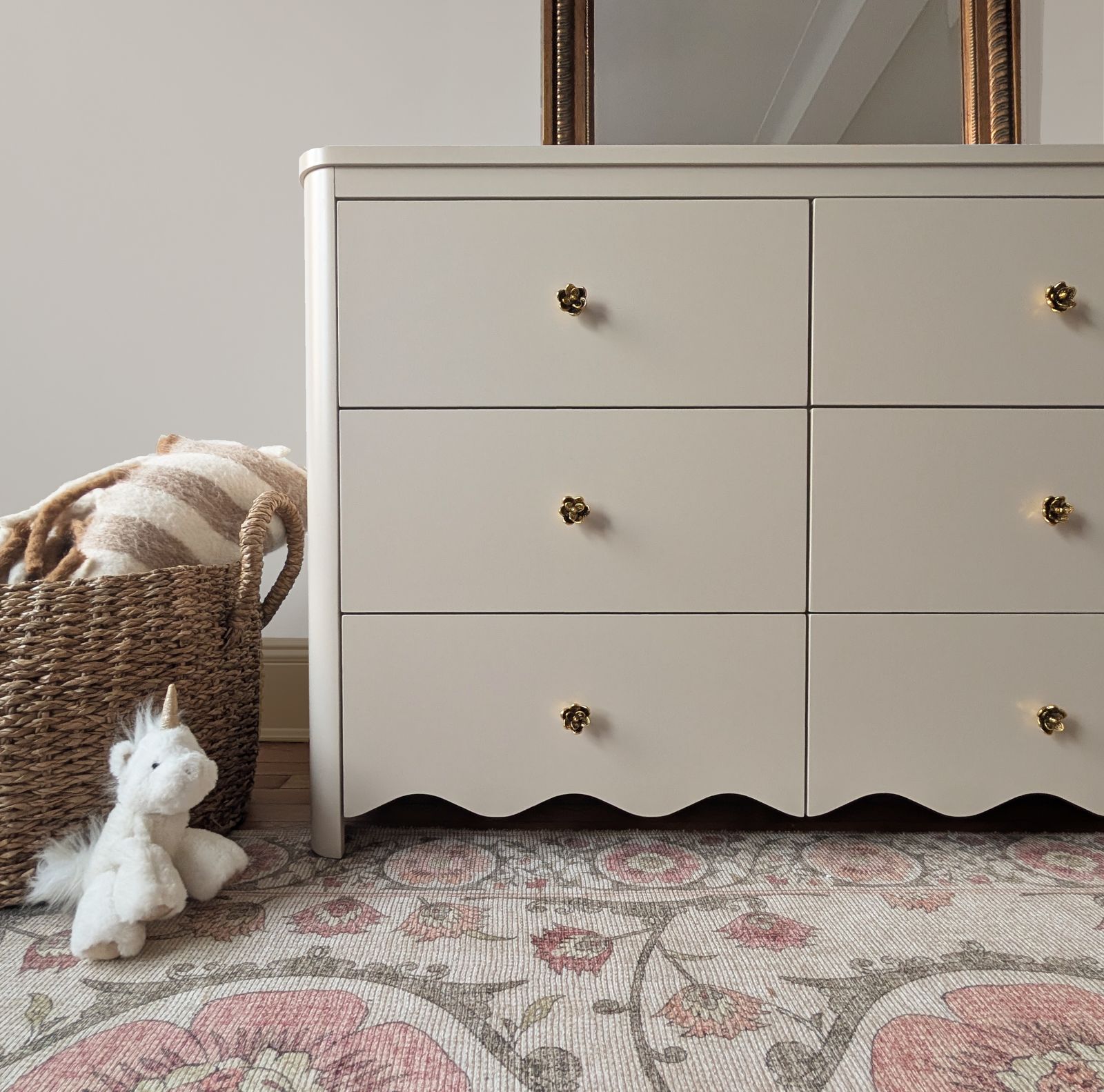 Scalloped-edge dresser with flower-shaped brass knobs